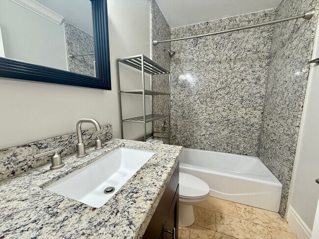 Building Photo - MOVE IN READY 2/2 with 2 Assigned Parking! In Unit Washer & Dryer! Gated Community! Centrally Loc...