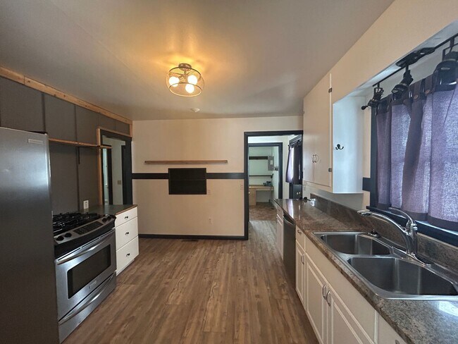 Building Photo - Bigfork Rodeo Farmhouse~ Fenced garden, greenhouse, garage, barn and shop!