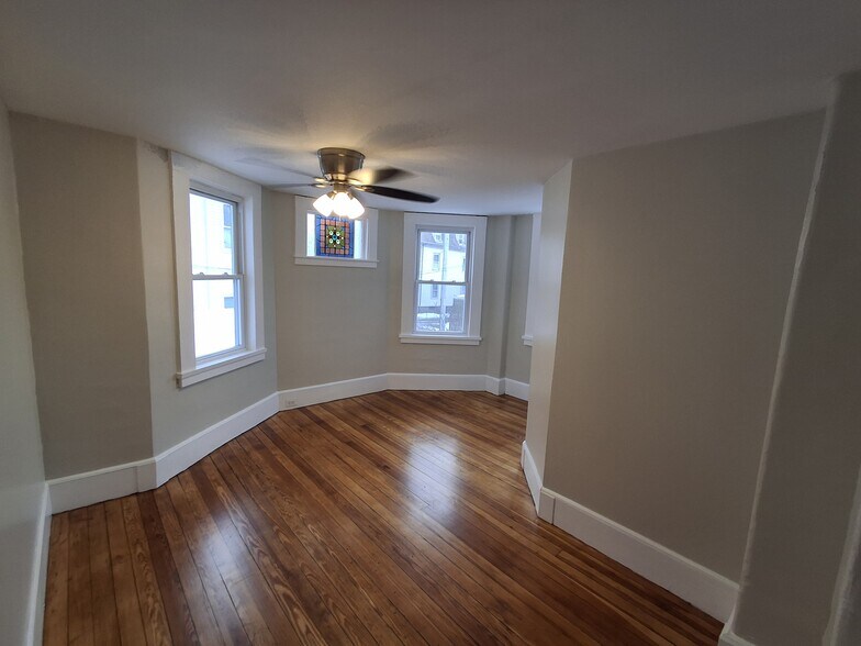 Dining Room: Newly refinished hardwood floor, new ceiling fan, original stained glass window. - 13 Mulberry St