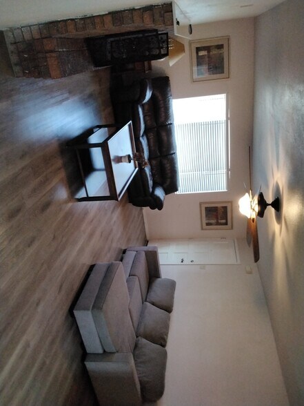 Furnished living room area with fireplace - 3253 W Country Gables Dr
