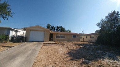 Building Photo - Large 2/2/1 1060 sq ft home with INDOOR LAUNDRY, a full garage, updated kitchen and a fenced in y...