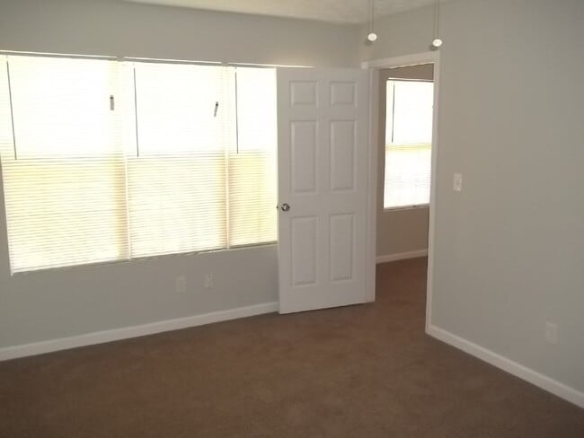 Building Photo - Freshly painted and new flooring in this 4 Bedroom 2 and Half Bath home. Covered front porch with...