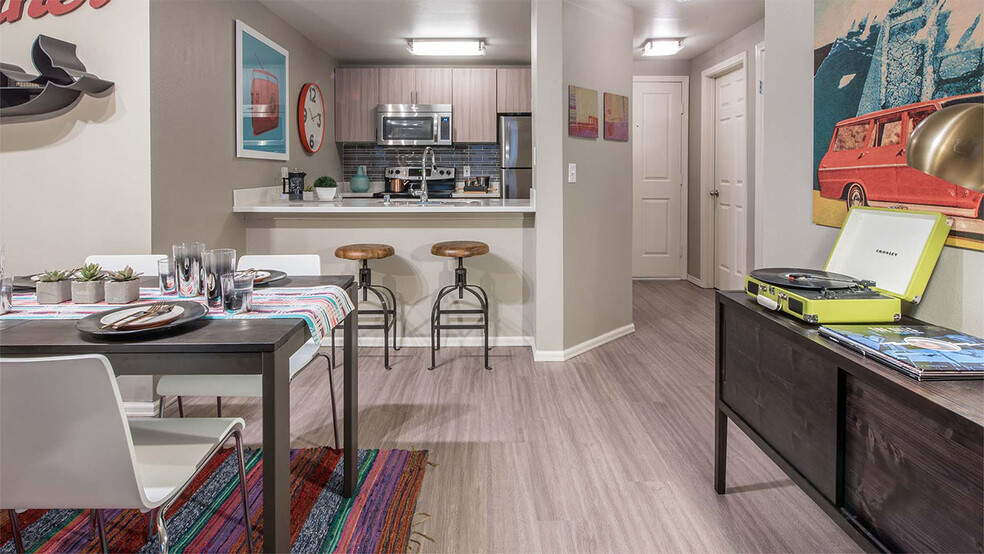 Apartment Kitchen with Stainless Steel Appliances and Dining room and with wood flooring. - Griffis Belltown