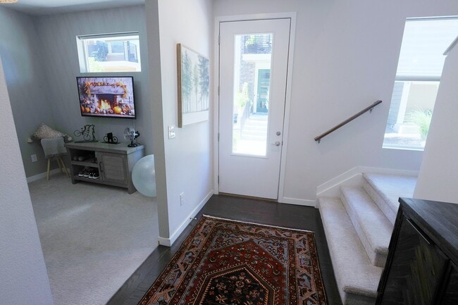 View from garage door to front door on lower level. Side view into Den on lower level - 15637 E Broncos Pl