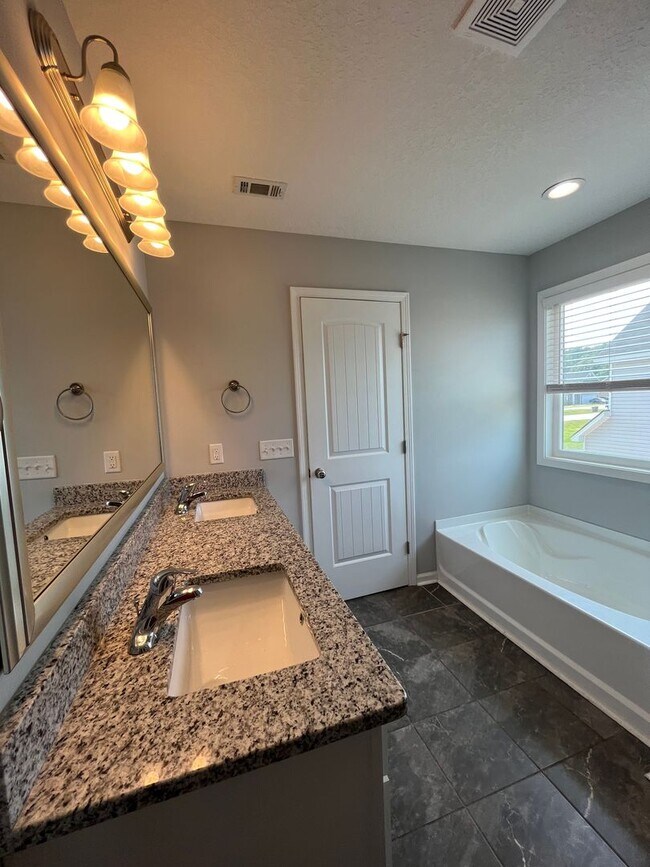 Building Photo - Spacious 4-Bedroom Pet Friendly Home with a Serene View - Available for Rent!