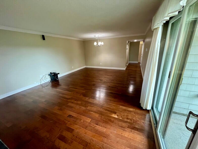 View from fireplace towards dining area, with kitchen beyond - 77 Windward Ln