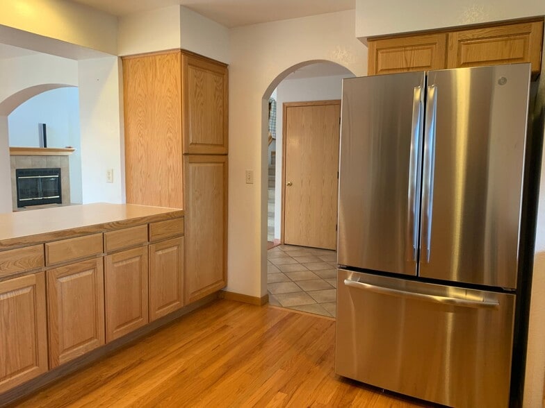 Kitchen island and SS Refrigerator - 2232 Sweetwater Creek Dr