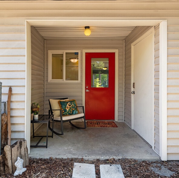 Covered back porch with secure storage area access. - 7051 8th Ave NW