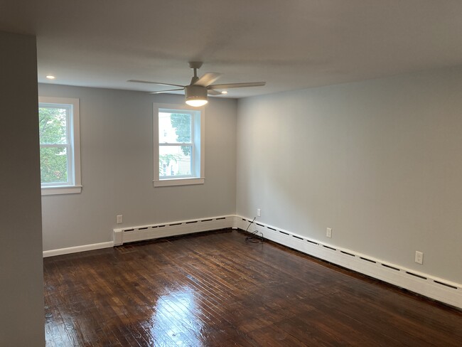 From the 2nd floor hall, you'll enter the primary bedroom. This large room has 3 windows, 2 closets - 2621 E Somerset St