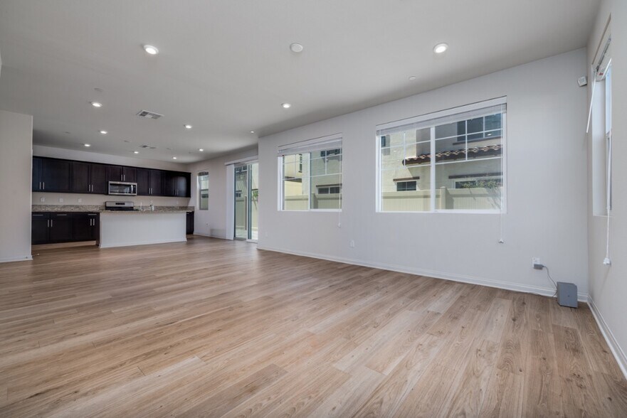 Another view of the spacious living area featuring laminate flooring - 26549 Brightstone Dr