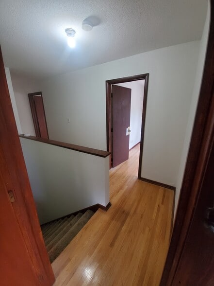 Hallway from Bedroom #1 Hardwood floors throughout upstairs - 1182 Lane Pl