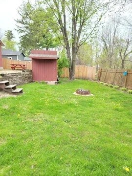 Garden shed and fire pit in back yard. - 438 E 7th St