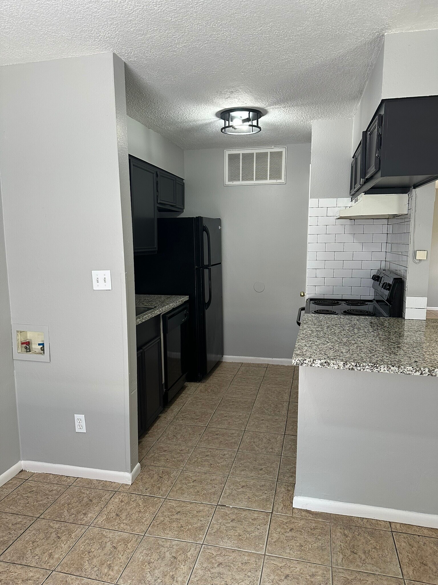 Laundry hook up, Black appliances, subway tile, granite countertops, large closet style pantry - 705 Edgar St