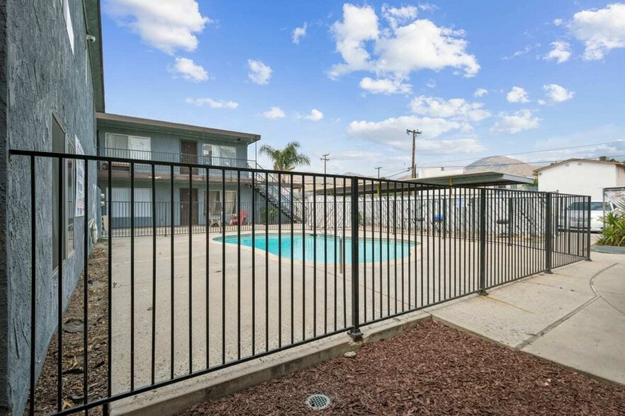 Villa Park a pool is seen behind a black iron fence Exterior view of pool - Villa Park