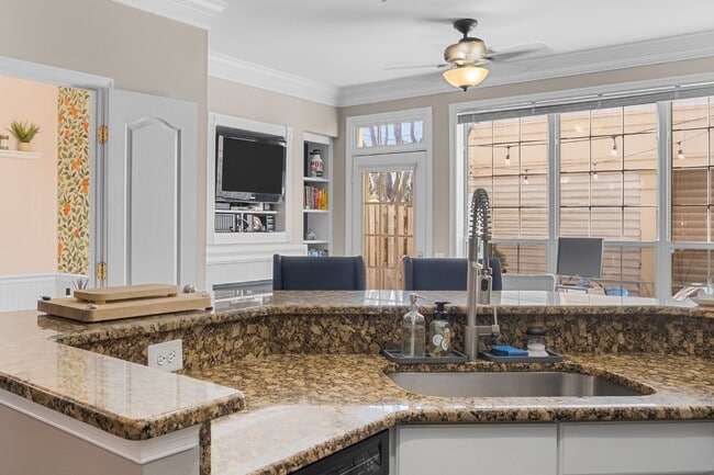 Building Photo - This inviting two-level townhome offers comfort and style, featuring gleaming hardwood floors on ...
