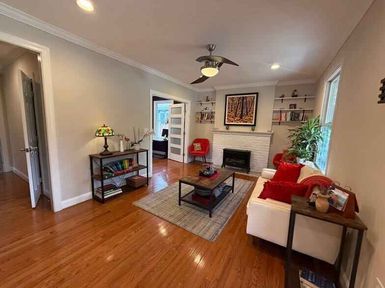 Living room, at the front door. Gas fireplace and lots of light. - 5715 7th St N