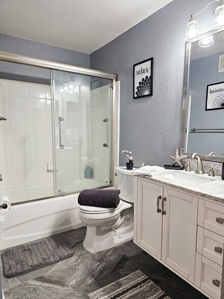 The private guest bathroom features a shower/tub feature and all the other essentials - 8923 Manor Loop