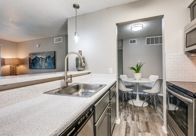 Dallas Apartments – Open Kitchen with Bar Seating & Dining Area - Fountains of Jupiter Apartments