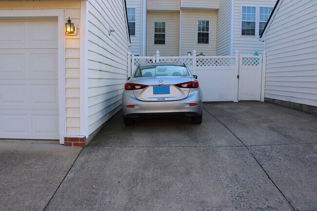 The back has a garage for storage and your own space to park for free (where the silver car is). - 7837 Heaton Way