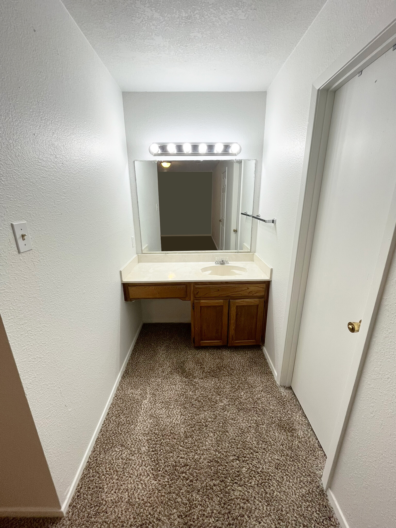 A separate bedroom vanity with a built-in mirror, lights, sink, cabinet, and drawer - 4917 Jamesway Rd