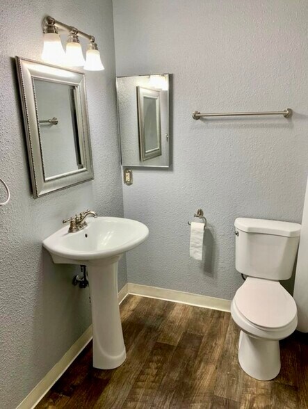 Bathroom with pedestal vanity and shower/tub with linen closet for more storage. - 872 Tanager St