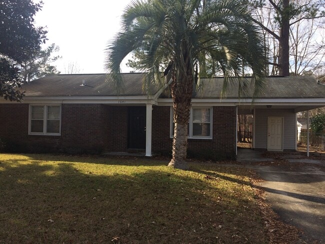 Building Photo - Brick Home with Carport & Fenced yard