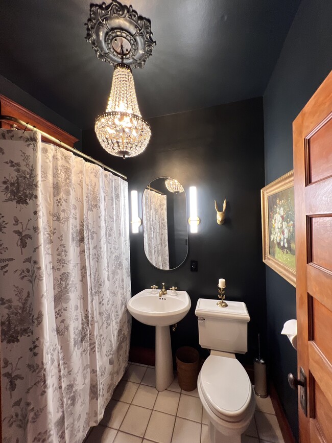 The luxurious bathroom with ball and clawfoot tub. Great for relaxing. - 2424 Stevens Ave