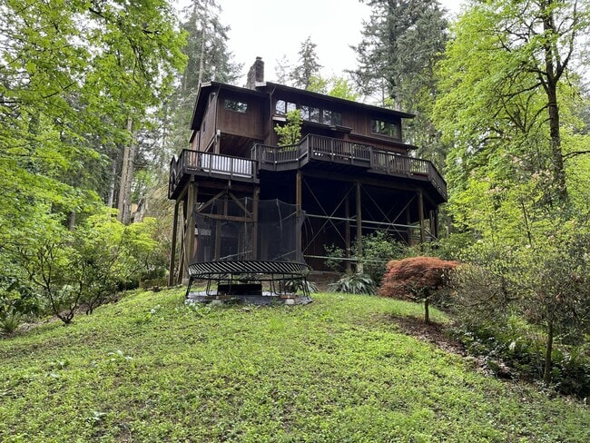 Building Photo - One-of-a-Kind Custom Home with Wall of Windows, Stone Fireplaces, Expansive Entertainment Space &...
