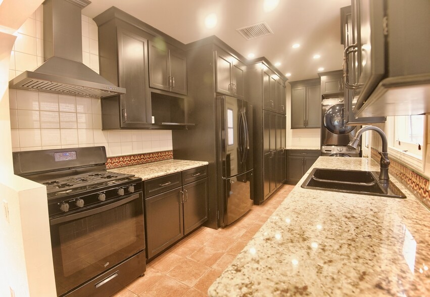 Kitchen with granite countertops and updated appliances - 4755 Wiota St