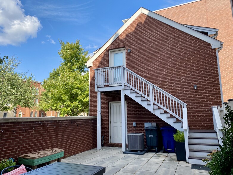 Stairs lead up to the unit from the patio. - 2115 Main Line Blvd