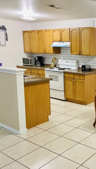 Kitchen includes full size refrigerator, stove and dishwasher. - 6748 Trail Lake Dr