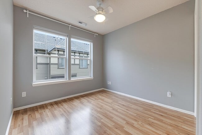 Building Photo - Lovely and bright townhouse with a hard wood flooring throughout, a 2 car garage, AC & more!