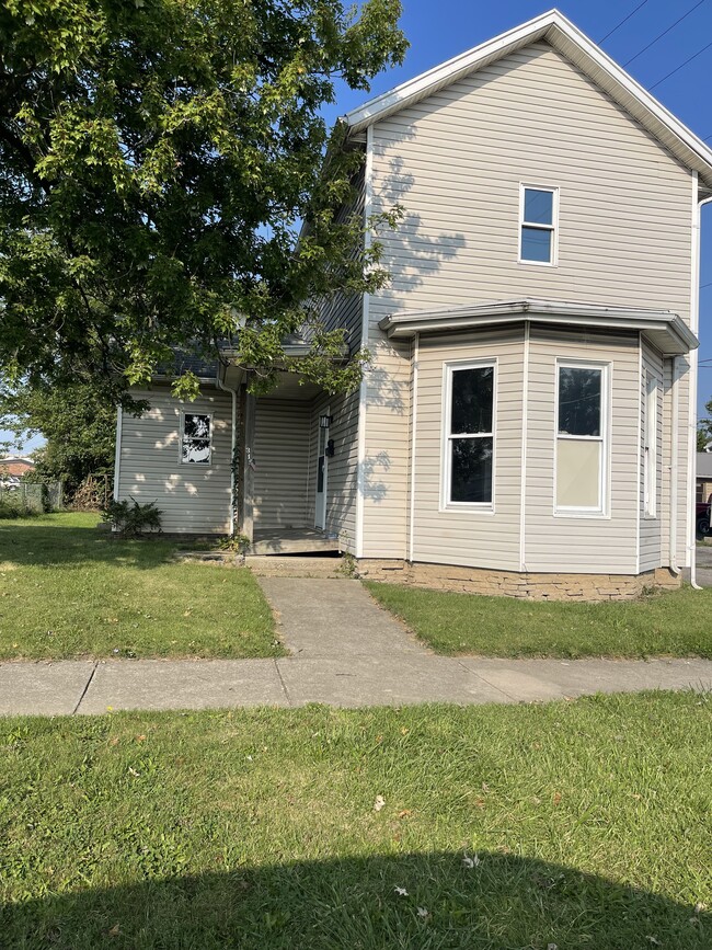 front of home with covered porch. window to be replaced - 319 N Pierce St