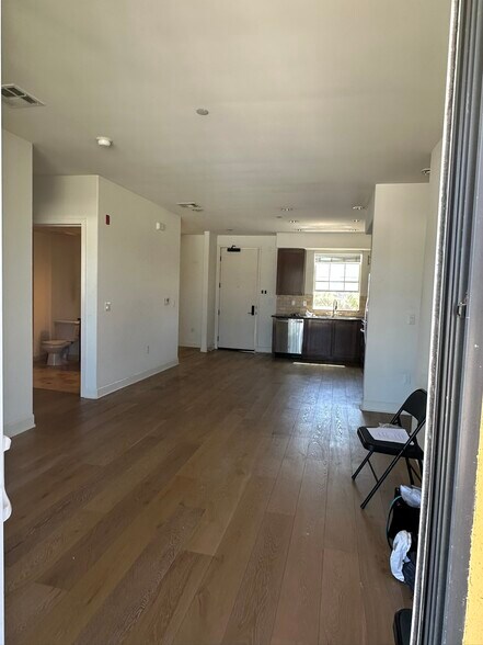 view from living room back toward kitch, front door and den/office far left - 130 N Garden St