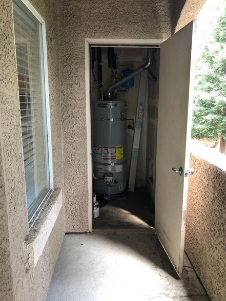 Storage closet off patio with newer water heater - 10001 Woodcreek Oaks Blvd