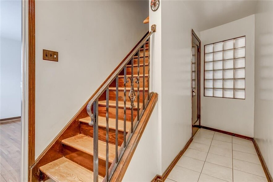 Front entry way. Unit 1 is to the left, Unit 2 at the top of the stairs, basement under staircase - 1453 Woodbine St