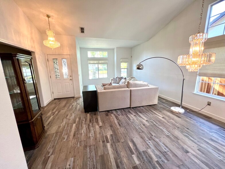 Living room and dining room under chandelier on right - 1288 Canevari Dr