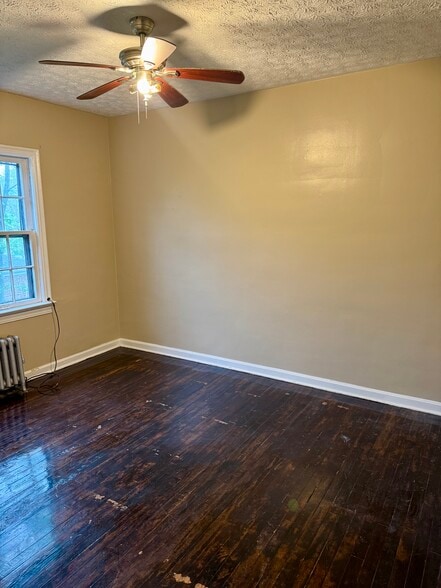 Comfortable bedroom with hardwood floors and natural light. - 3682 Glencairn Road