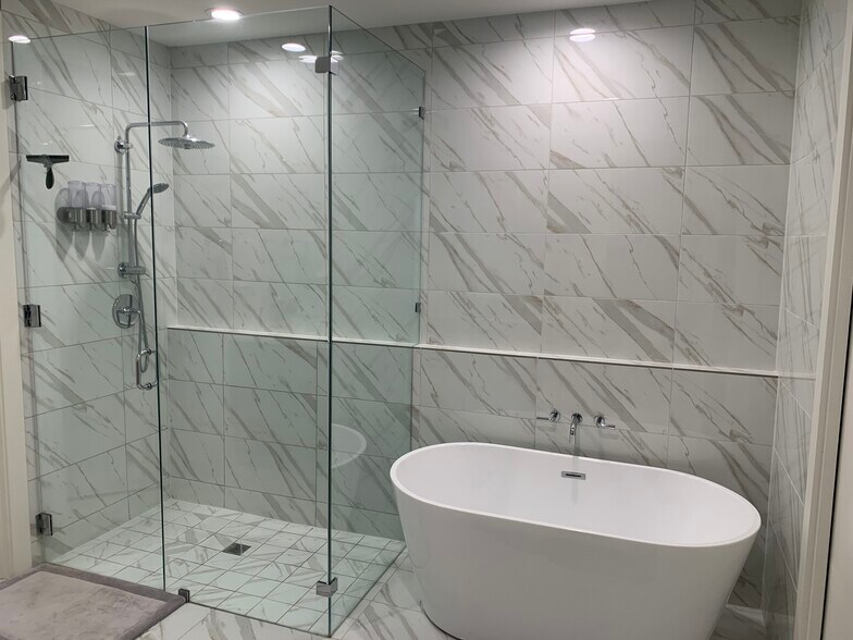 Frameless glass shower with Grohe rain shower head and handheld. Free standing sulking tub - 3923 Cole Ave