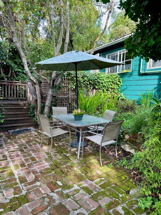 Shared patio with table and umbrella - cottage is in the background. - 1515 Valley Rd