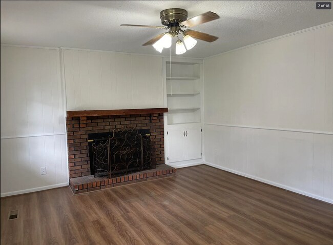 Spacious Living Room with ceiling fan, mantle, and built-in storage - 714 Woodland Dr S