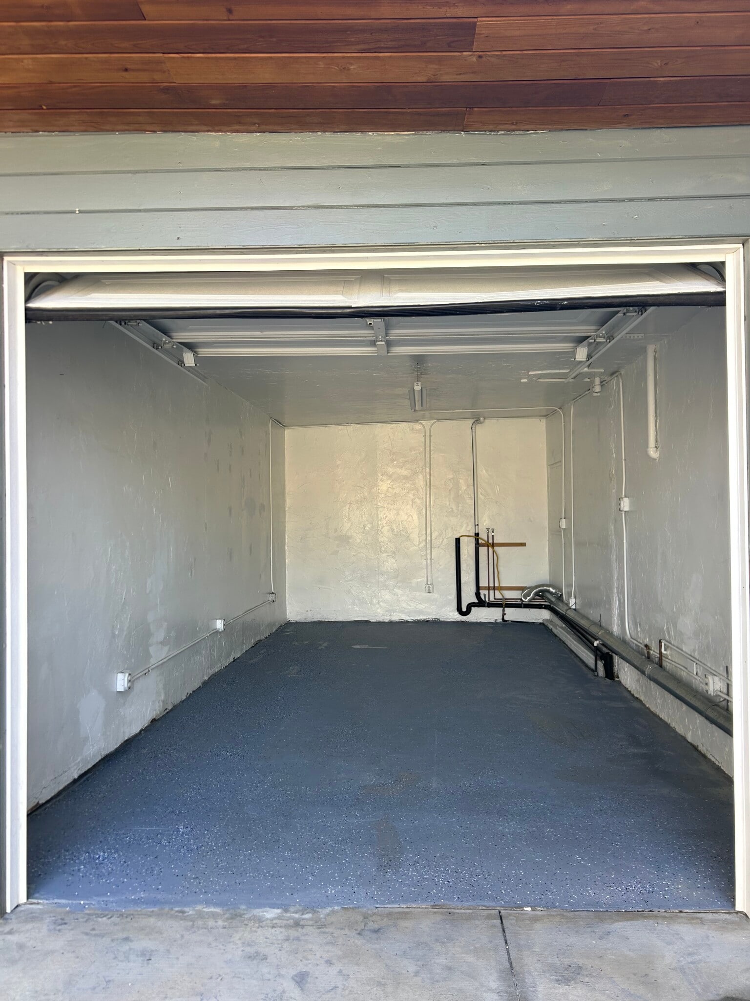 open garage (hook-ups for washer & dryer appliances); parking for one car - 642 E 10th St