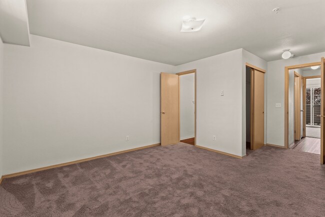 Comfortable bedroom with generous furnishing space. - Villas at Lawrence