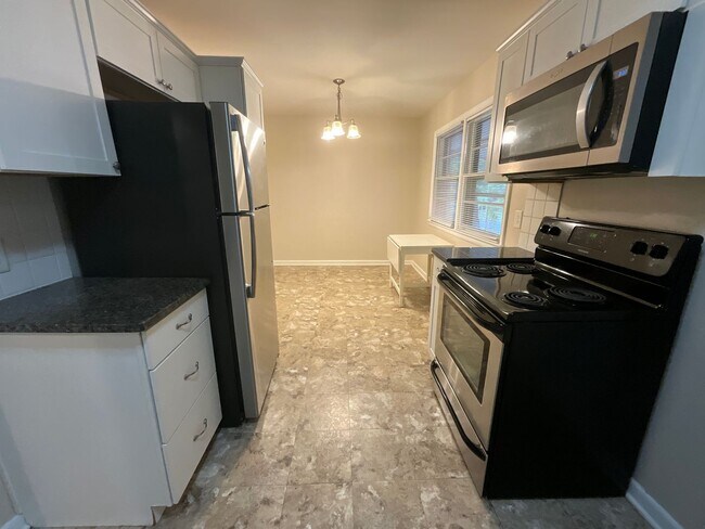 Building Photo - Reduced to $1550/mo! N Central Greensboro location, 3/2 brick home with lots of shade, fresh paint!