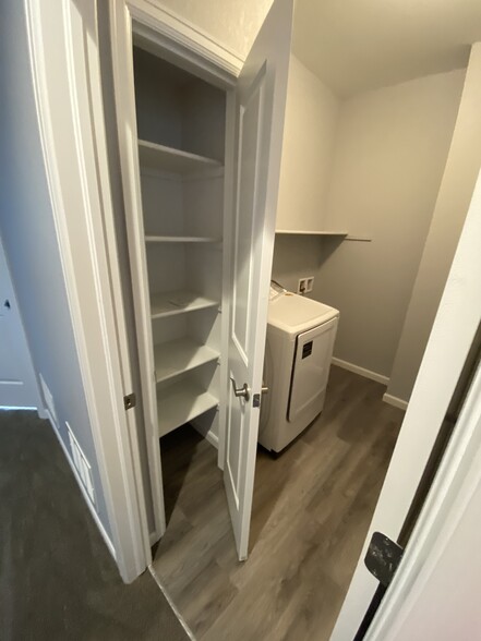 Upstairs utility room with storage and new Samsong washer and dryer - 16155 W 62nd Ln