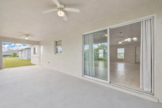 Building Photo - Spacious Three-Bedroom Home with Open Floor Plan, Large Yard & Screened Patio