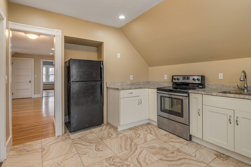 Updated kitchen featuring stainless steel appliances and granite countertops. - 5 Larchmont Rd