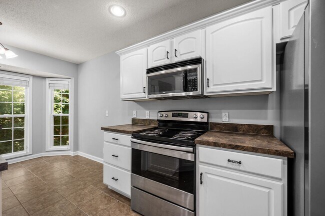 Building Photo - Stunning Stone Fireplace • Finished Basement • Fenced Yard