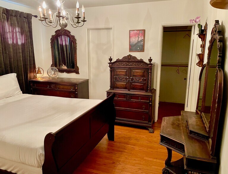 Vintage antique bedroom furniture accents the master bedroom that has its own bathroom - 11449 Woodbine St