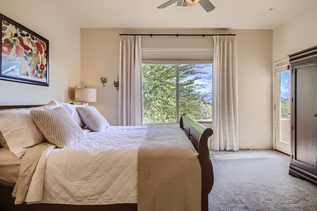 Primary bedroom with king-size bed; looking out to mountain views - 19475 N Grayhawk Dr